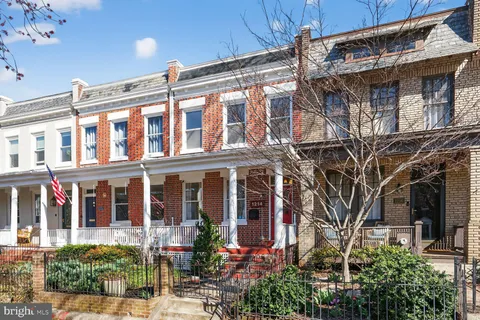 a view of a brick building with a door and a chair
