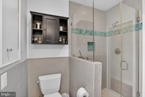 a bedroom with a large bed and a night stand