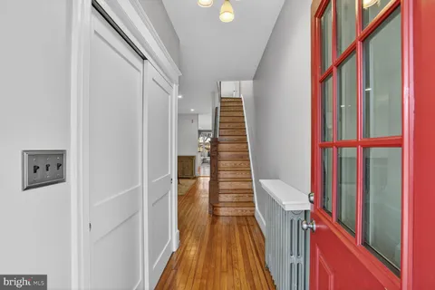 a view of a dining room with furniture wooden floor and a chandelier