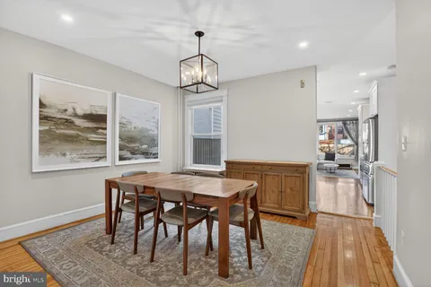 a view of a dining room with furniture wooden floor and chandelier