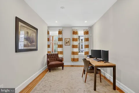 a workspace with furniture and wooden floor