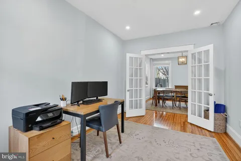 a kitchen with a stove and a wooden floor