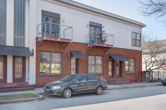 a brick building with a bench in front of it