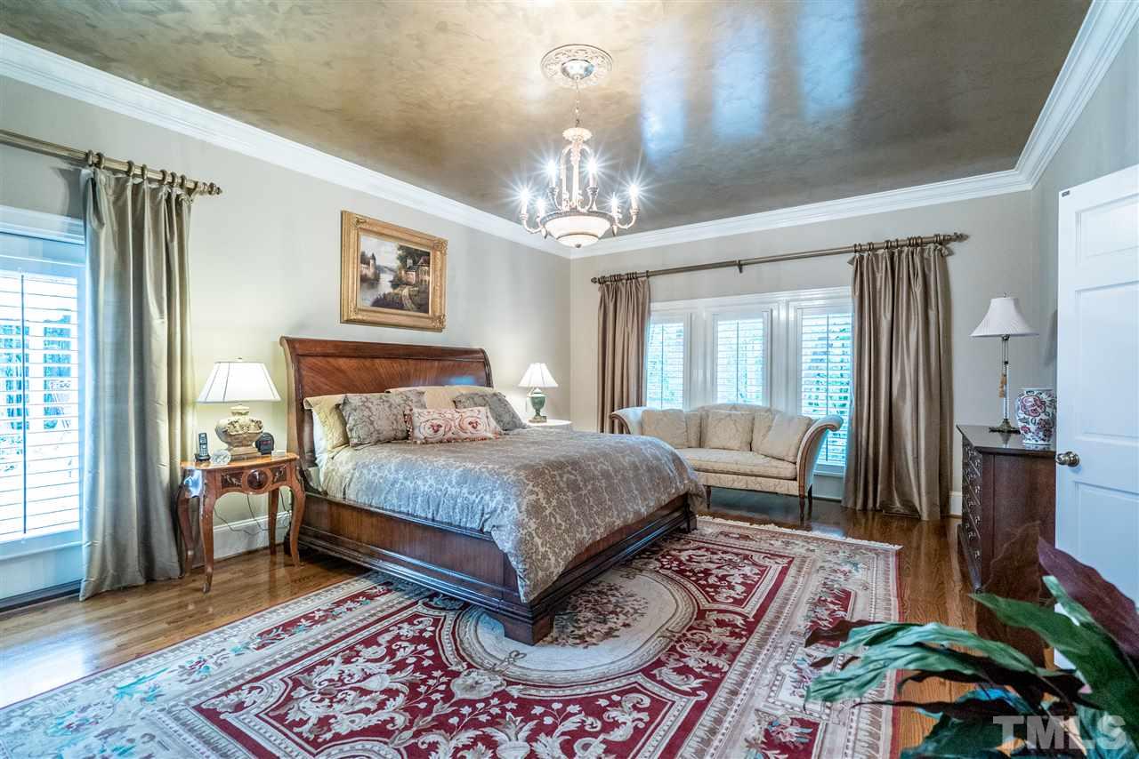 9904 Mathias Court Raleigh, NC 27615 - Photo 11 of 25 a bedroom with a bed rug and window