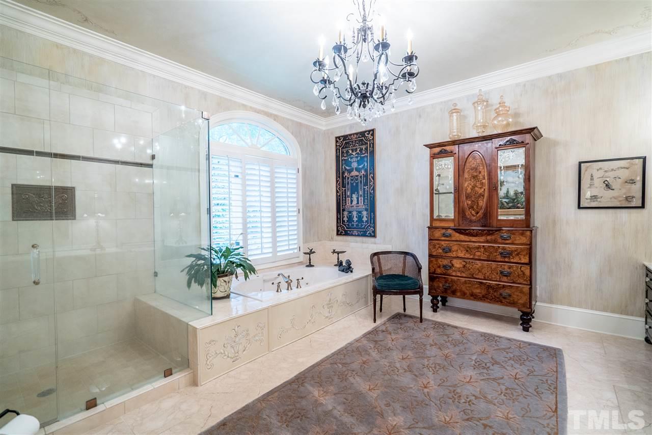 9904 Mathias Court Raleigh, NC 27615 - Photo 13 of 25 a spacious bathroom with a bathtub and a shower