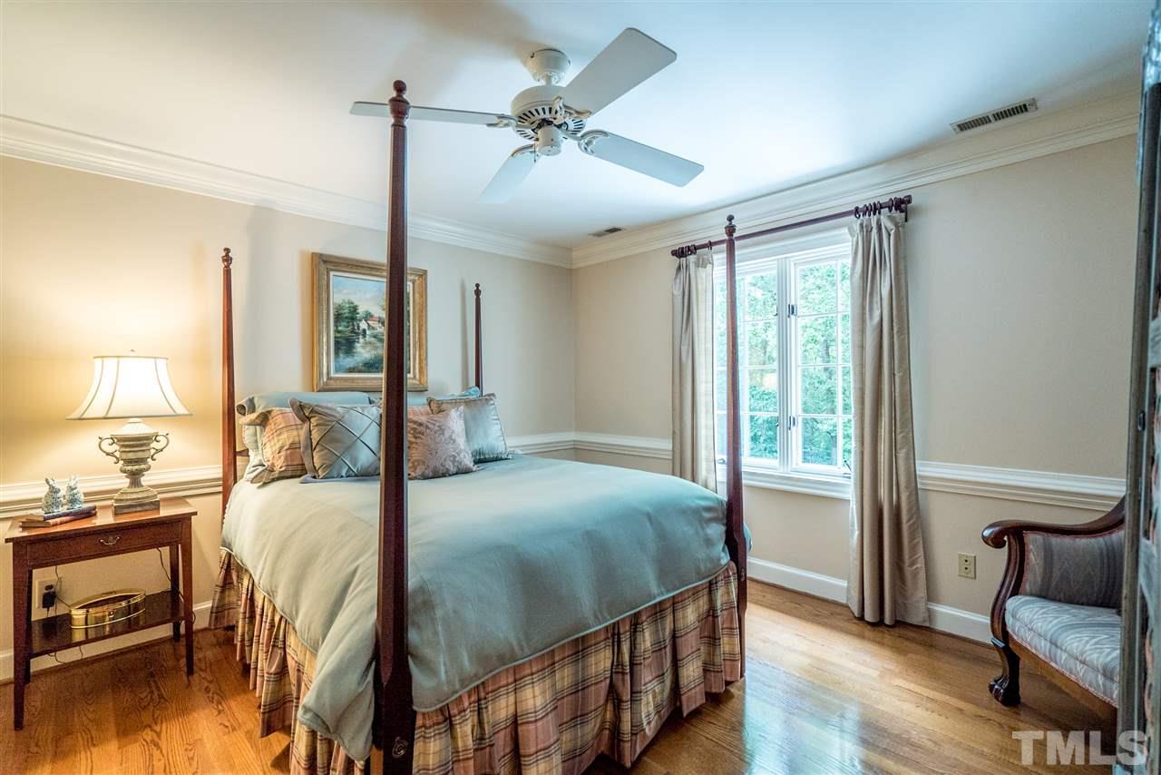 9904 Mathias Court Raleigh, NC 27615 - Photo 14 of 25 a bedroom with a bed window and a table