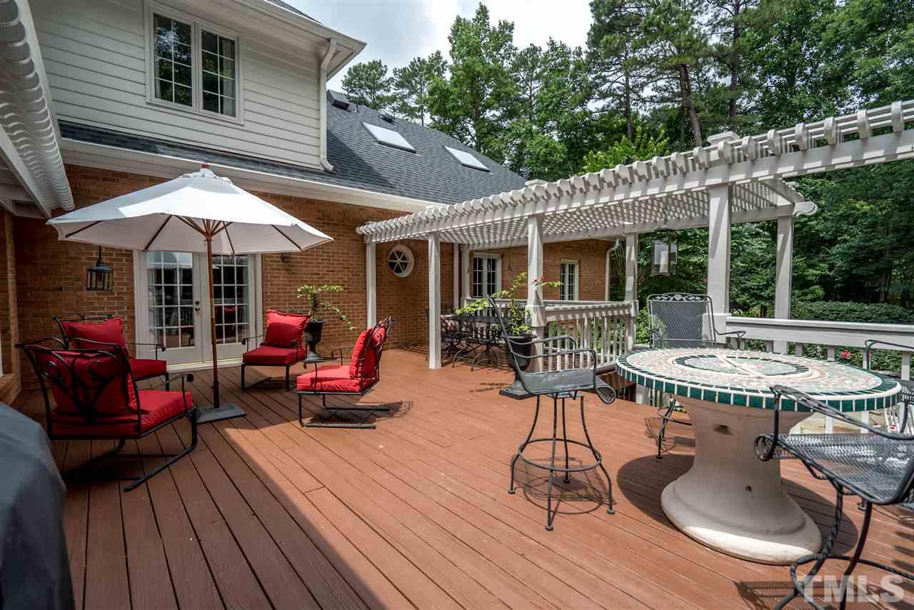 9904 Mathias Court Raleigh, NC 27615 - Photo 19 of 25 a view of a patio with table and chairs potted plants with wooden floor