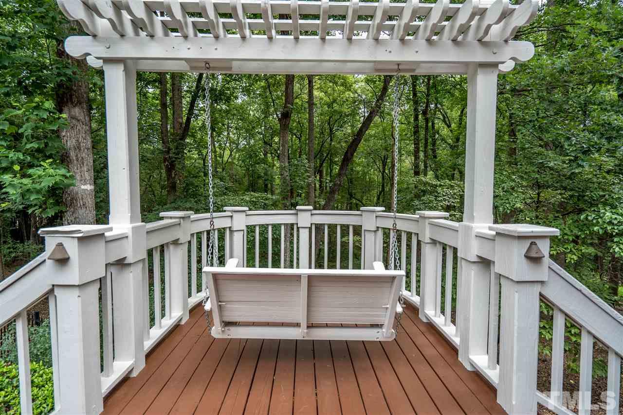 9904 Mathias Court Raleigh, NC 27615 - Photo 21 of 25 a view of a wooden deck and a yard with furniture