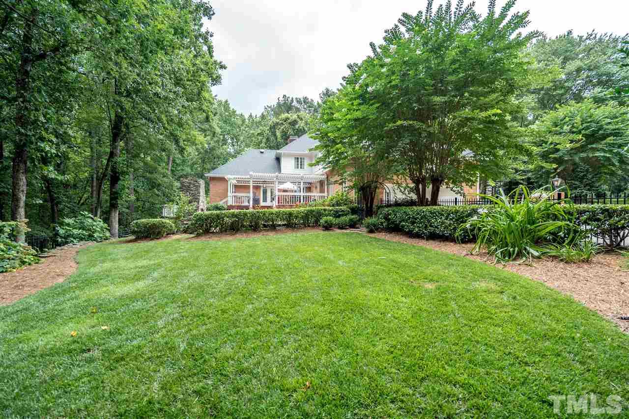 9904 Mathias Court Raleigh, NC 27615 - Photo 25 of 25 a view of a house next to a big yard and large trees