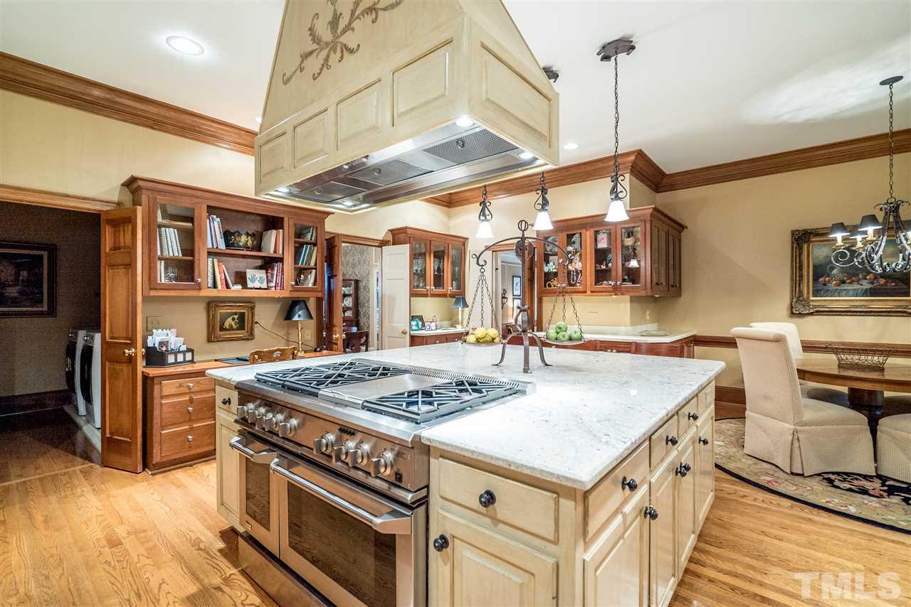 9904 Mathias Court Raleigh, NC 27615 - Photo 7 of 25 a kitchen with stainless steel appliances granite countertop a stove and a refrigerator