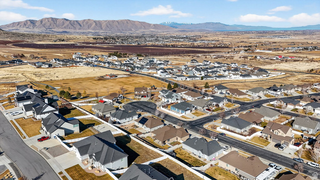 141 Wolverine Creek Elk Ridge, UT 84651 - Photo 44 of 47 Aerial view of property's location featuring nearby suburban area and a mountain backdrop