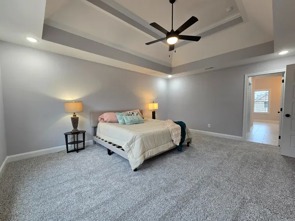 a bedroom with a bed and a chandelier