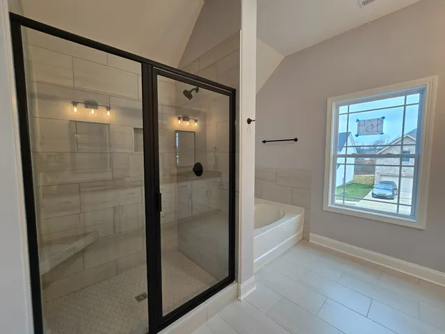 a bathroom with a bathtub and a shower