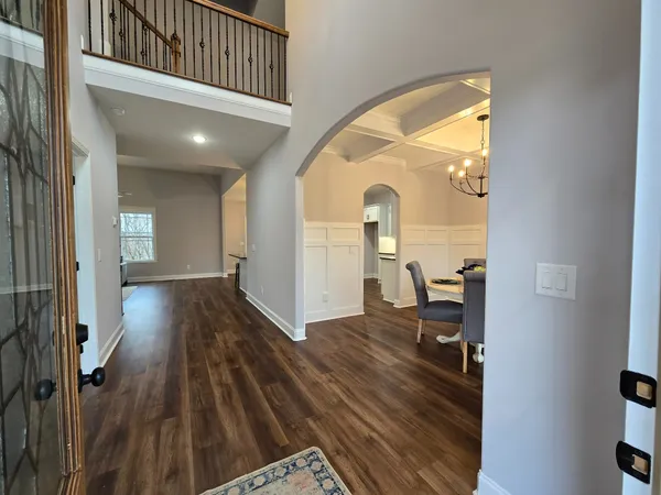 a view of a hallway to a livingroom and furniture