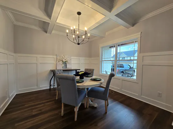 a view of a dining room with furniture wooden floor and chandelier