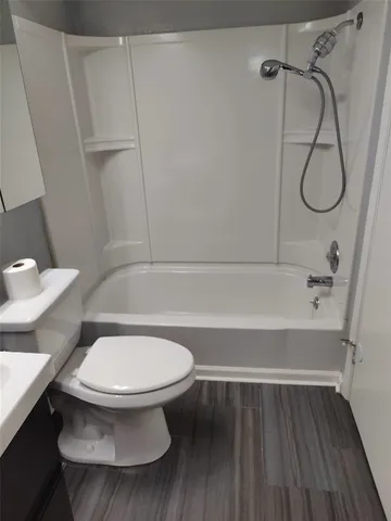 a bathroom with a toilet and a shower