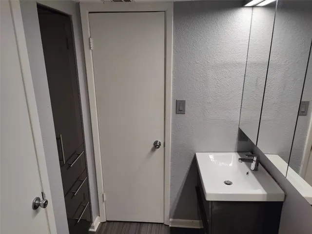 a bathroom with a sink a mirror and shower