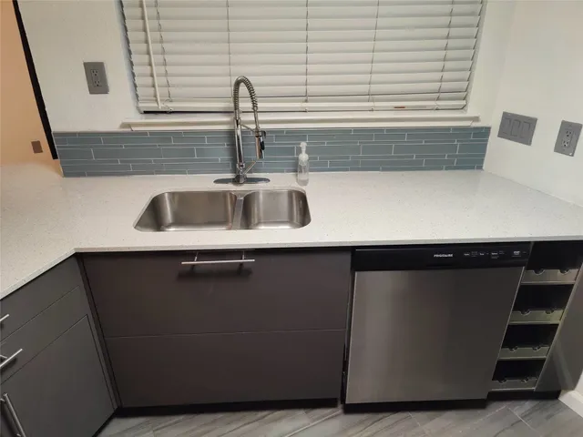 a kitchen with a sink and a window