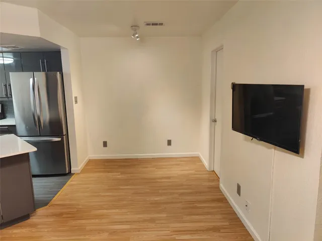 a kitchen with stainless steel appliances a refrigerator and a microwave