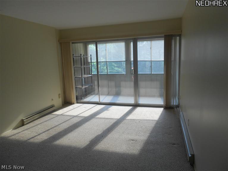 3066 Kent Road, Unit 302B Stow, OH 44224 - Photo 15 of 24 Spacious living room with sliders to enclosed porch