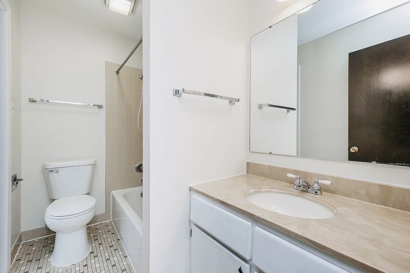 865 Sheldon Court, Unit C Wheaton, IL 60189 - Photo 8 of 11 a bathroom with a granite countertop sink toilet and shower