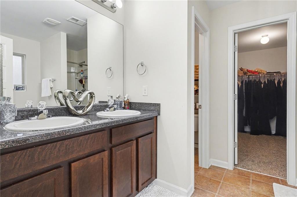 1241 England Terrace Hampton, GA 30228 - Photo 11 of 20 a bathroom with a granite countertop sink and a mirror