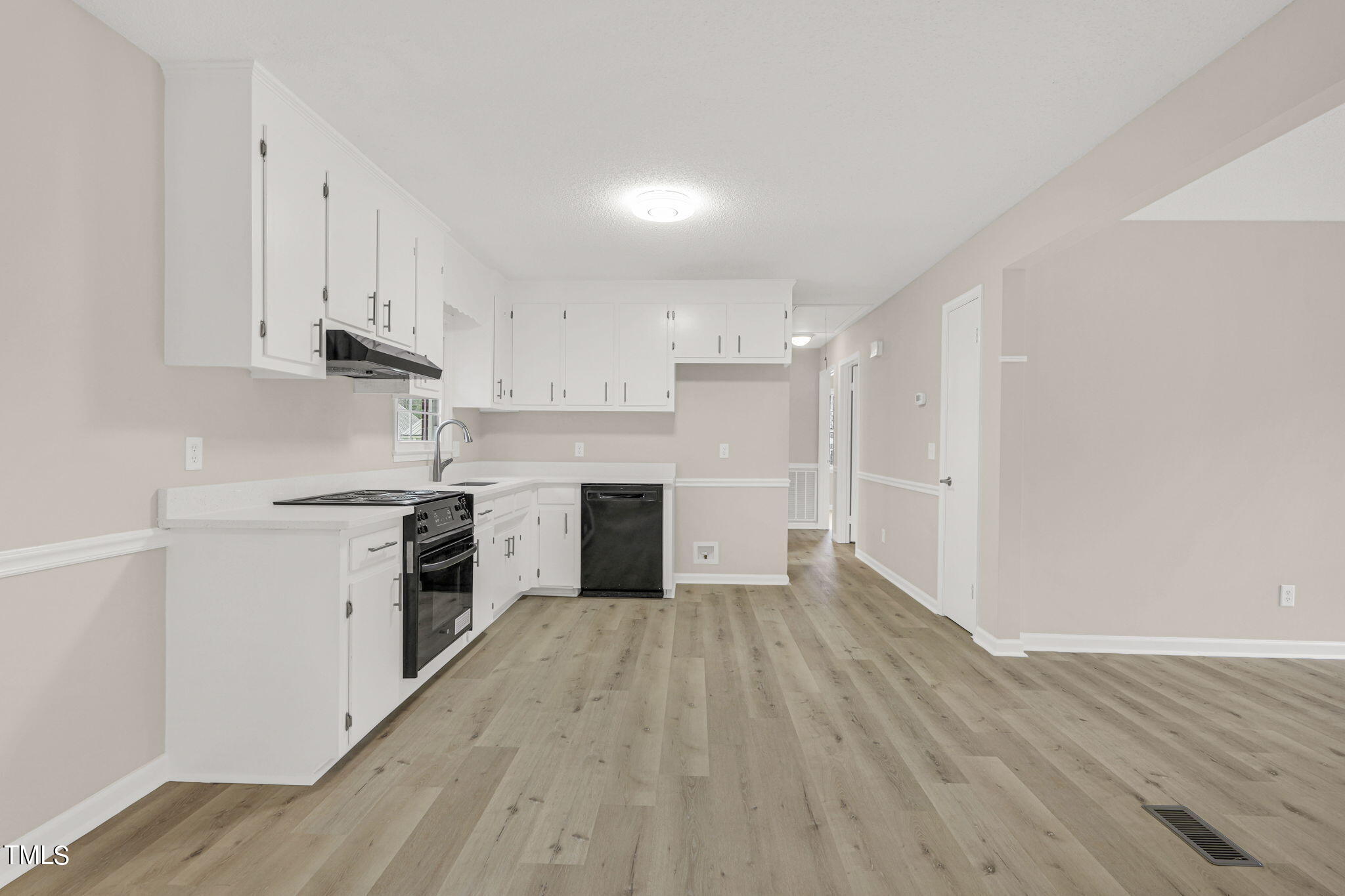 1073 Brick Mill Road Coats, NC 27521 - Photo 11 of 32 a kitchen with granite countertop white cabinets and white appliances