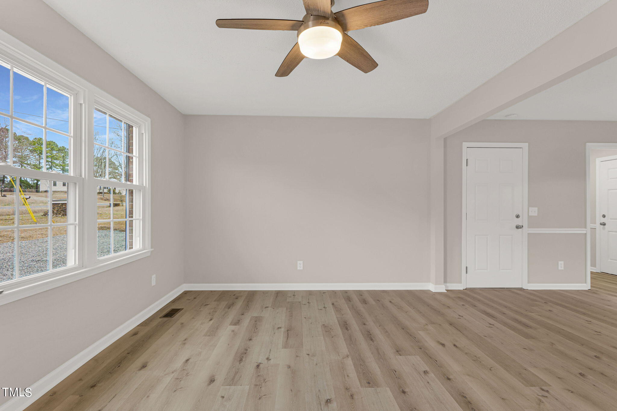 1073 Brick Mill Road Coats, NC 27521 - Photo 13 of 32 a view of empty room with wooden floor and fan