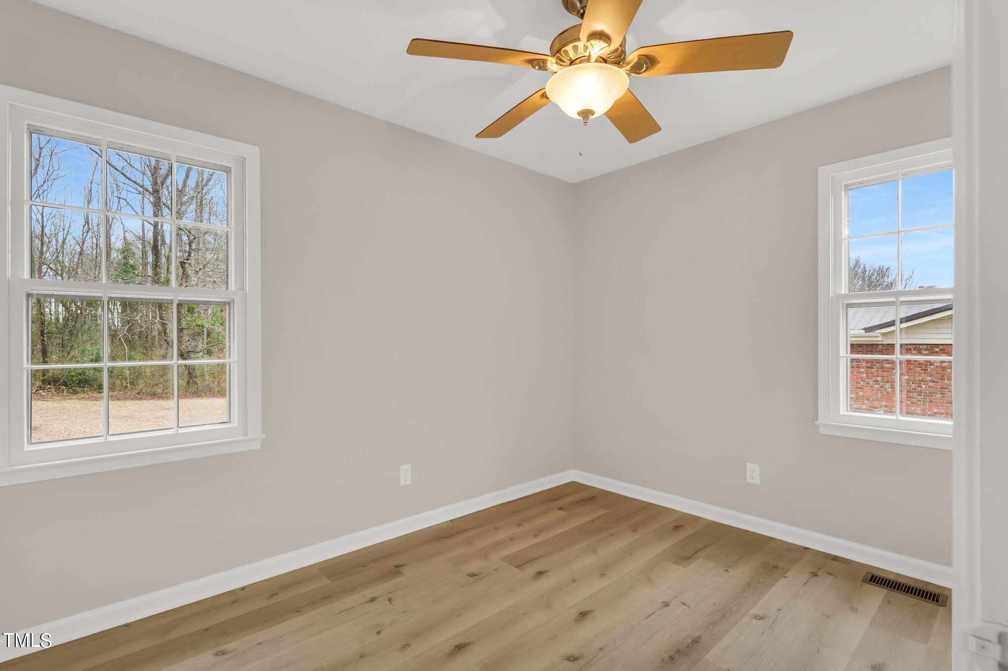 1073 Brick Mill Road Coats, NC 27521 - Photo 19 of 32 an empty room with wooden floor and windows