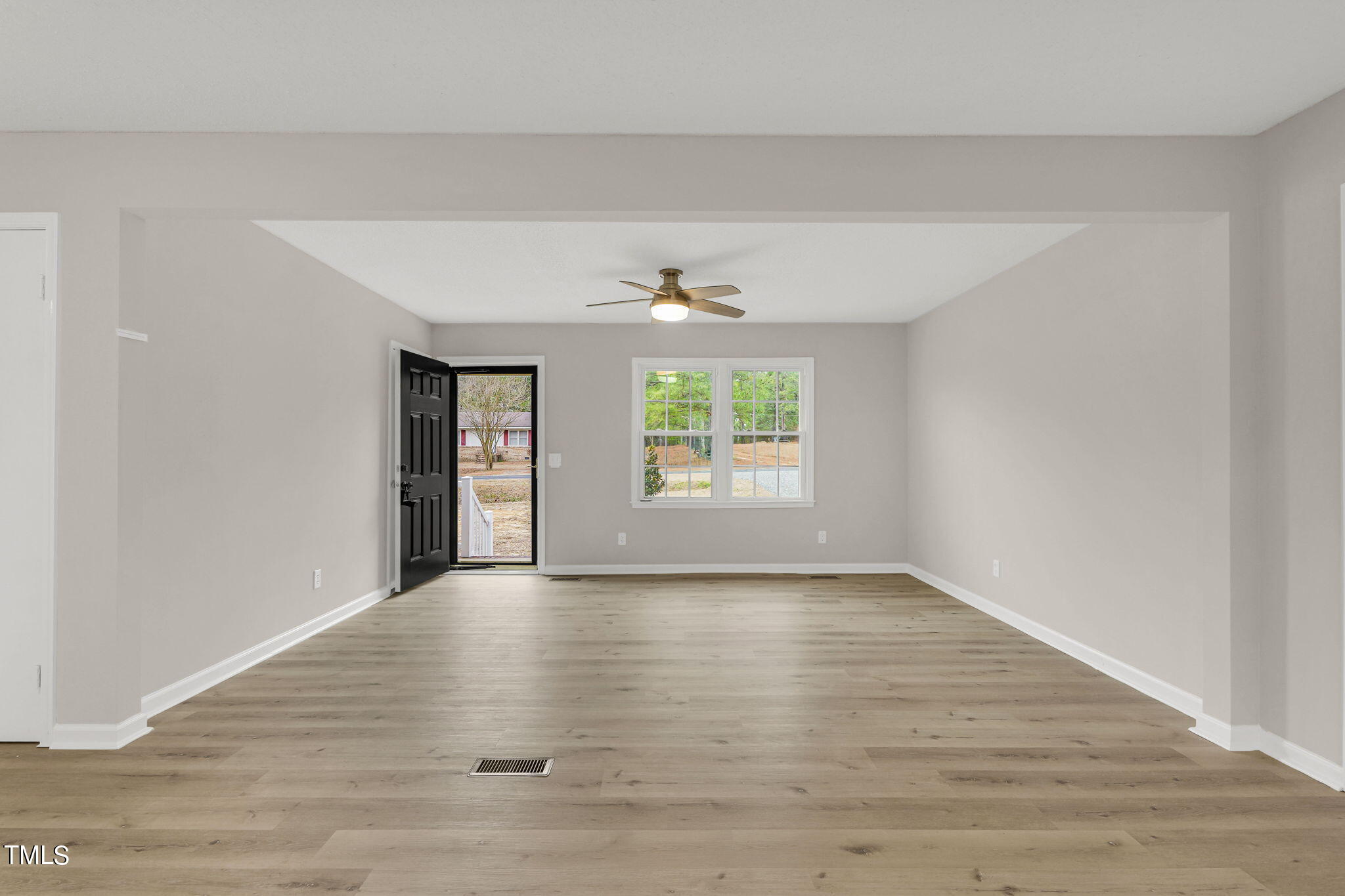 1073 Brick Mill Road Coats, NC 27521 - Photo 8 of 32 a view of an empty room with wooden floor and a window