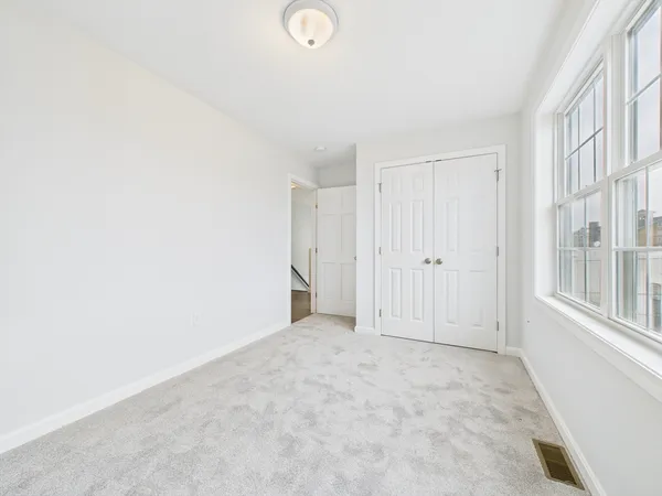 a bathroom with a granite countertop sink a toilet and shower
