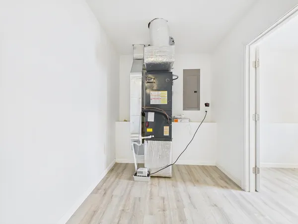 a view of a room with wooden floor and white walls
