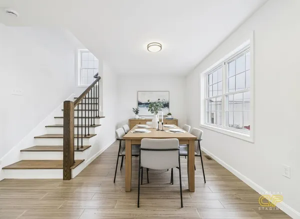 a view of a dining room with furniture window and wooden floor