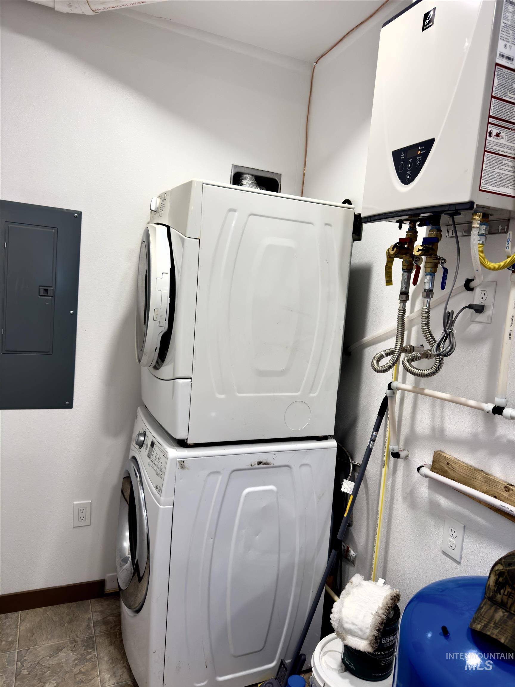 1112 Old Pk Road Deary, ID 83823 - Photo 15 of 23 Laundry area with electric panel, tankless water heater, and stacked washer and dryer