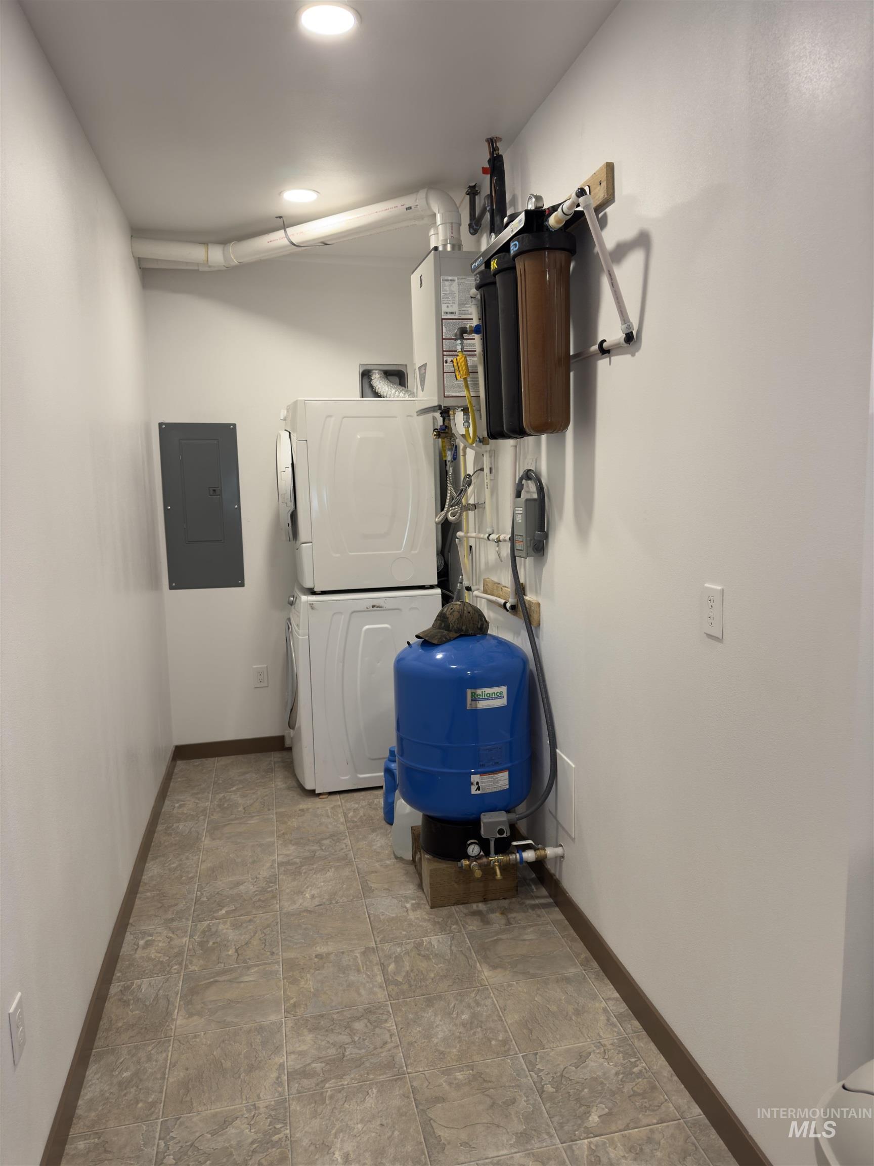 1112 Old Pk Road Deary, ID 83823 - Photo 16 of 23 Utility room with stacked washer and dryer, electric panel, and water heater