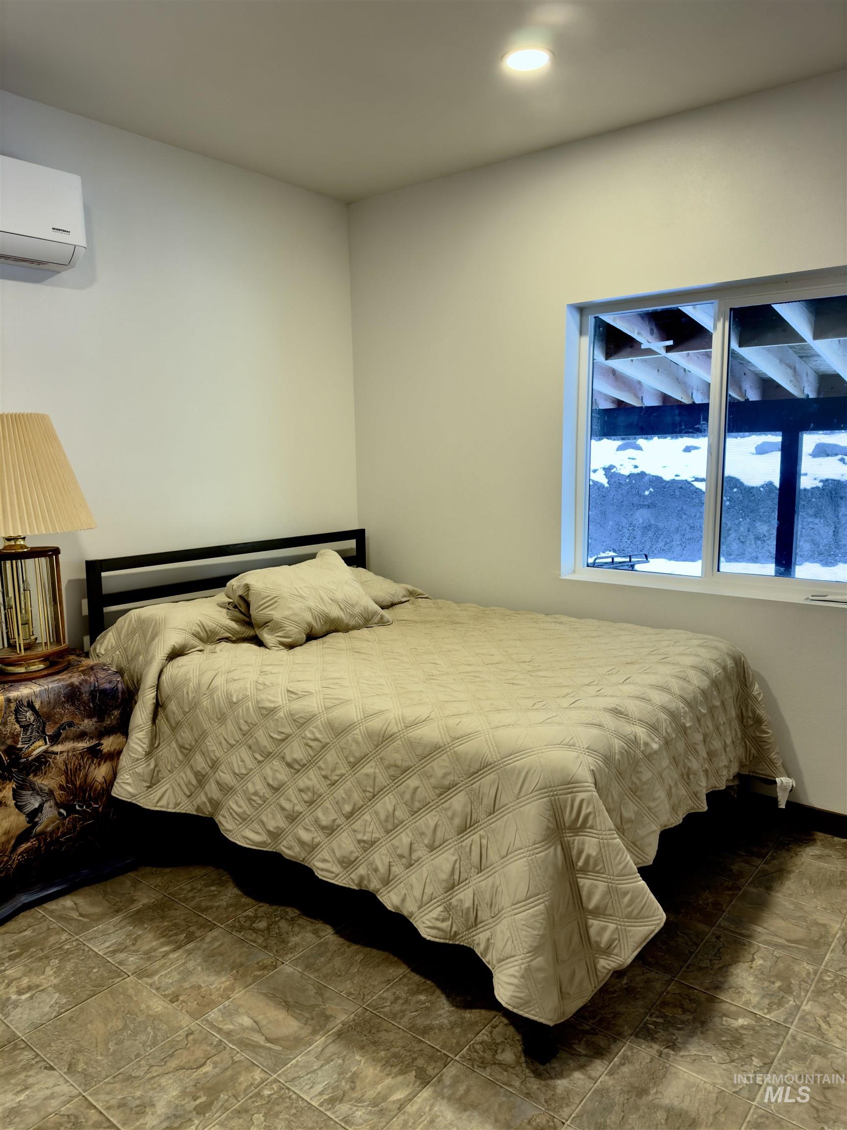 1112 Old Pk Road Deary, ID 83823 - Photo 18 of 23 Bedroom featuring a wall mounted mini split and stone finish flooring
