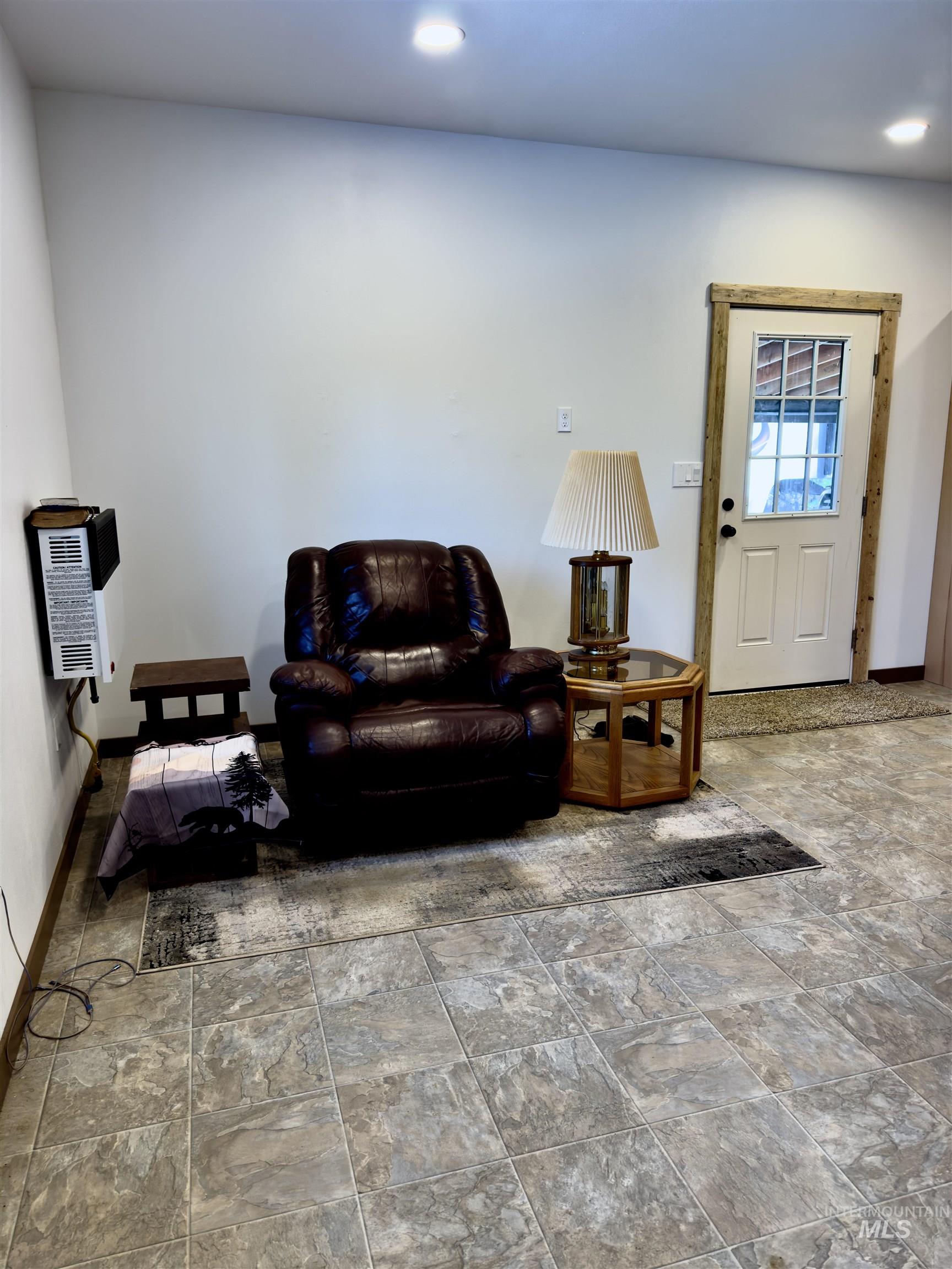 1112 Old Pk Road Deary, ID 83823 - Photo 20 of 23 Living area with stone finish flooring and heating unit