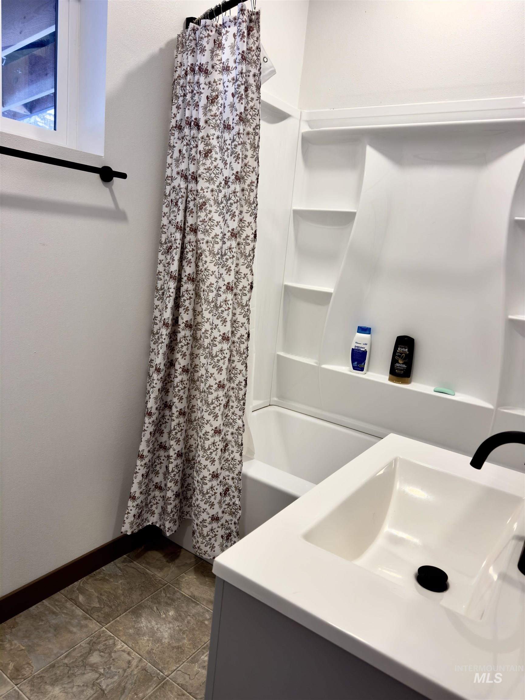 1112 Old Pk Road Deary, ID 83823 - Photo 23 of 23 Bathroom with vanity and shower / tub combo with curtain