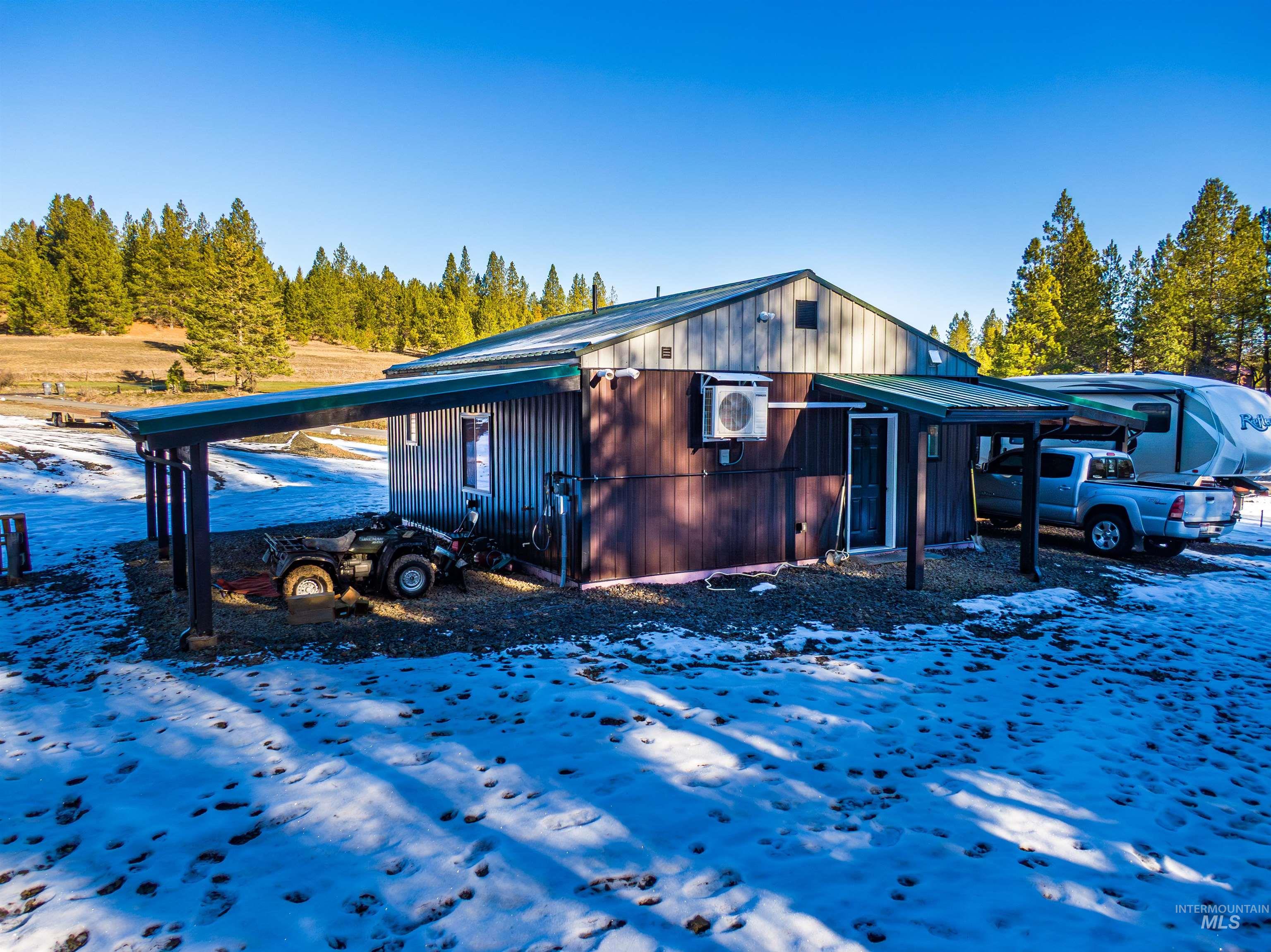 1112 Old Pk Road Deary, ID 83823 - Photo 6 of 23 Snow covered property with a cooling unit and a metal roof