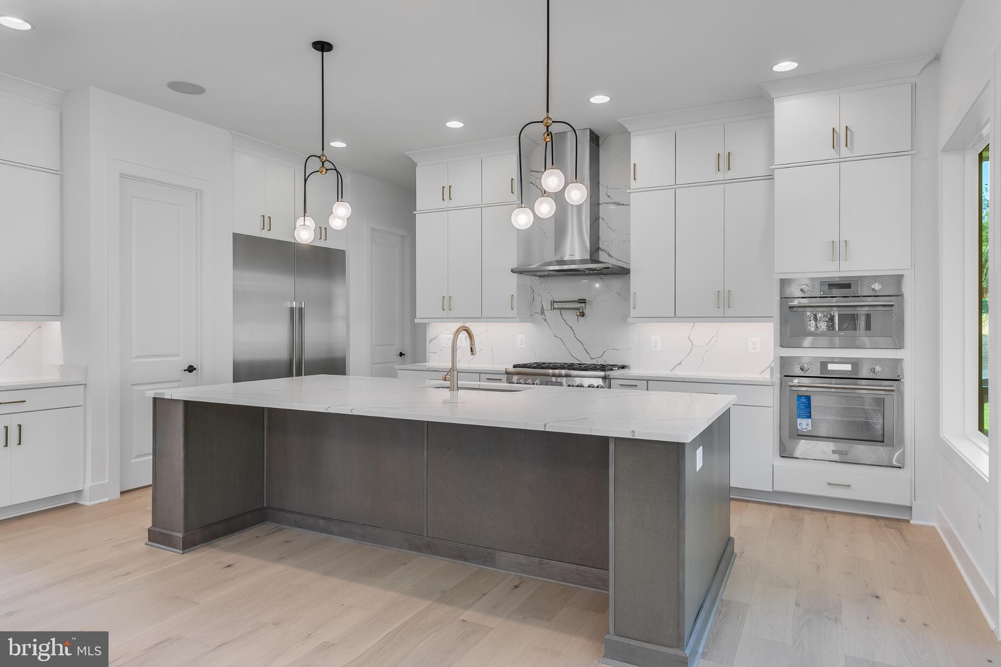 9209 Franks Point Lane Lorton, VA 22079 - Photo 6 of 16 a kitchen with kitchen island a sink stainless steel appliances and cabinets