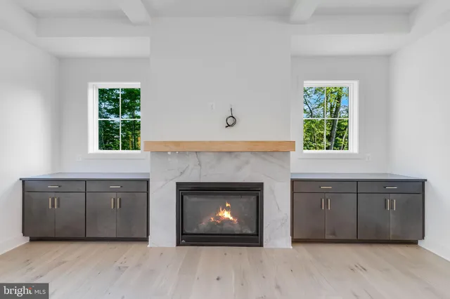 a spacious kitchen with a fireplace and a window