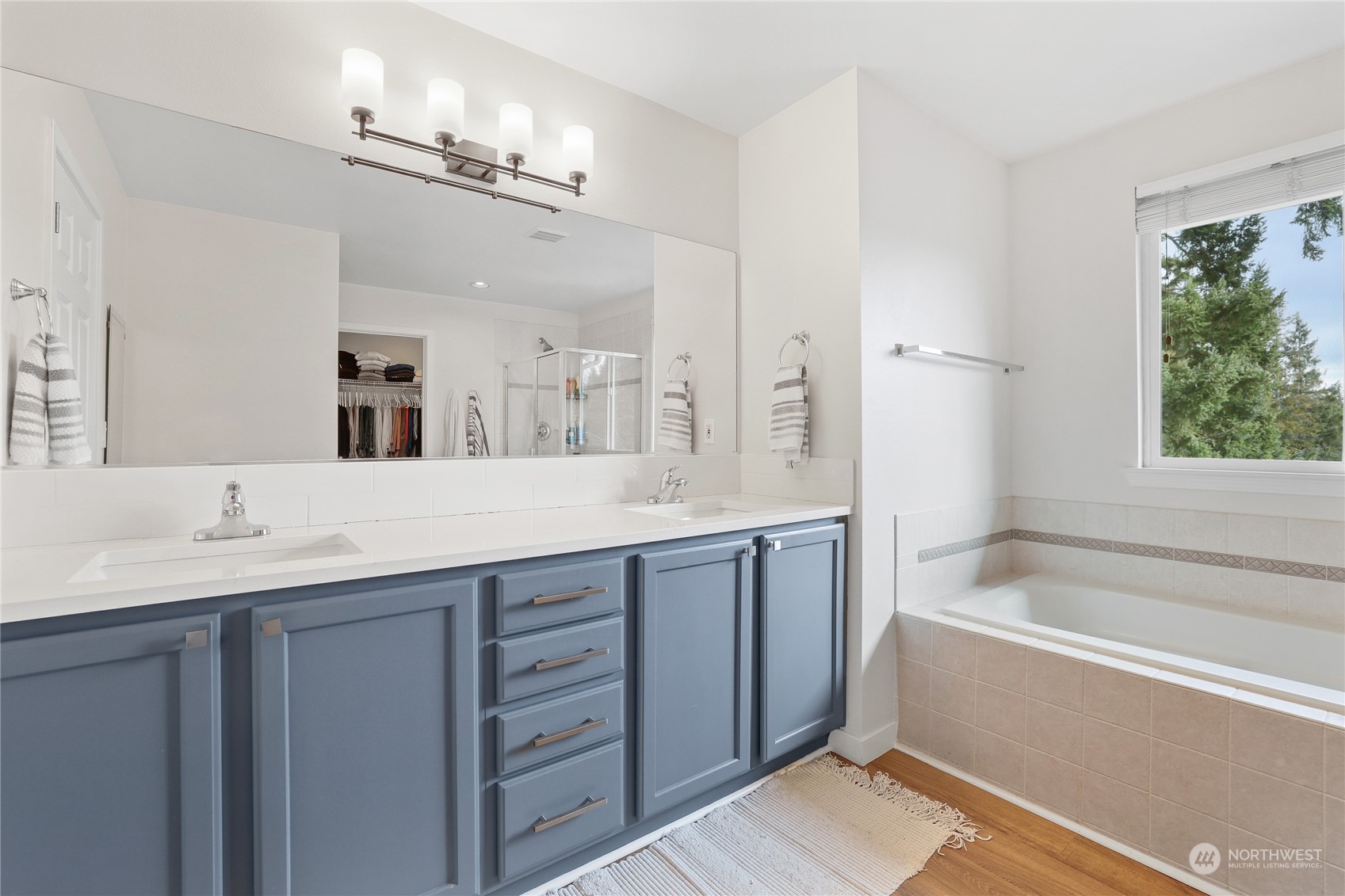 107 202nd Street Southeast Bothell, WA 98012 - Photo 20 of 34 a bathroom with a tub a sink double vanity and a mirror
