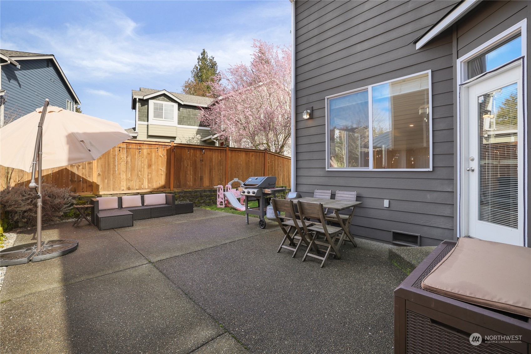 107 202nd Street Southeast Bothell, WA 98012 - Photo 29 of 34 a view of a patio with table and chairs with barbeque grill and wooden fence