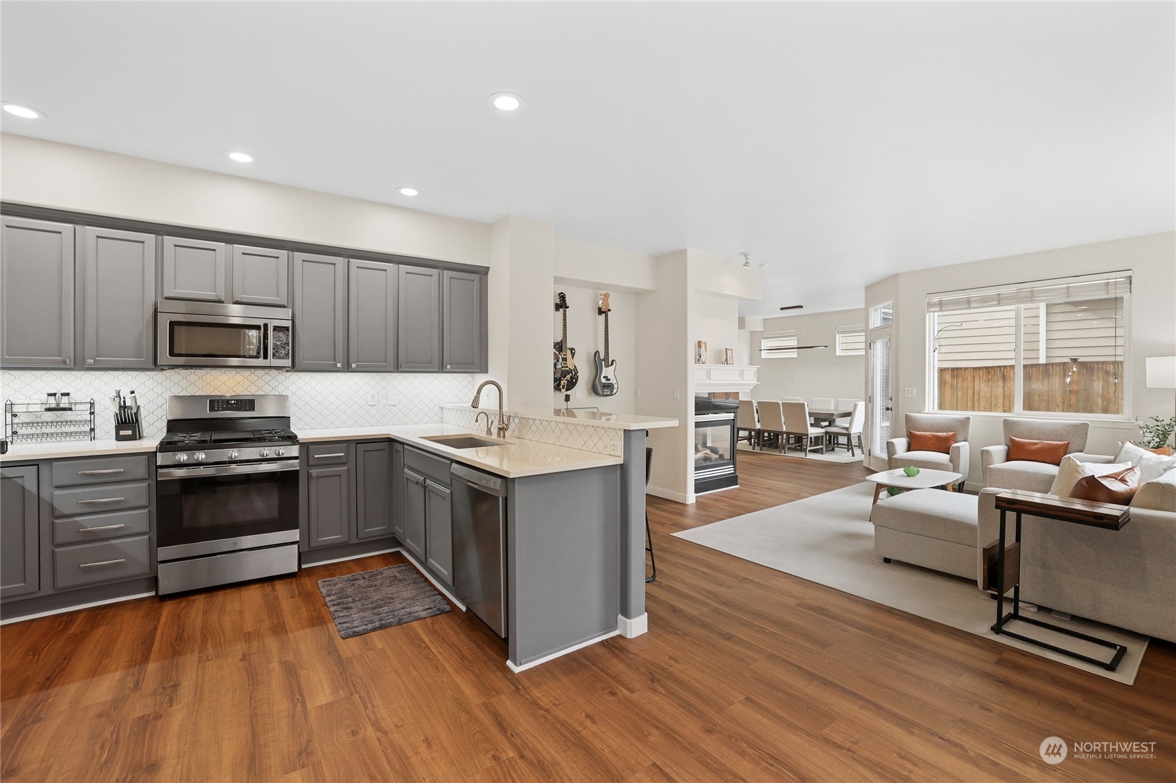 107 202nd Street Southeast Bothell, WA 98012 - Photo 10 of 34 a large kitchen with stainless steel appliances wooden floors and wooden cabinets
