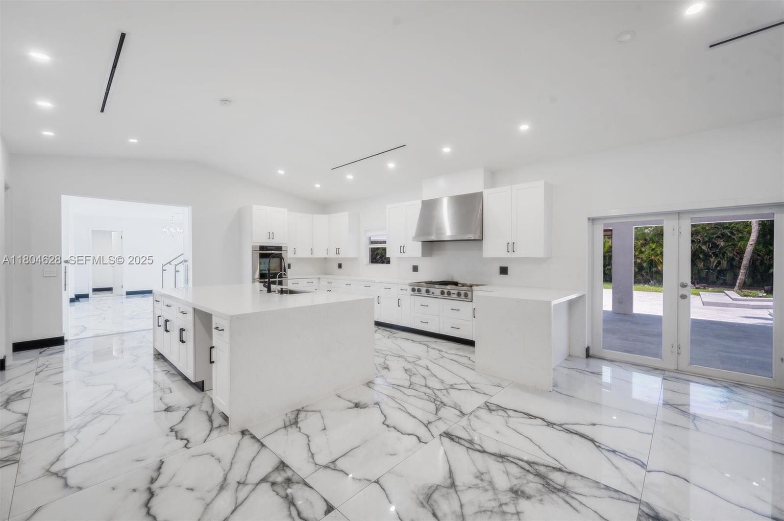 5121 Southwest 210th Terrace Southwest Ranches, FL 33332 - Photo 12 of 70 a large white kitchen with lots of counter top and stainless steel appliances
