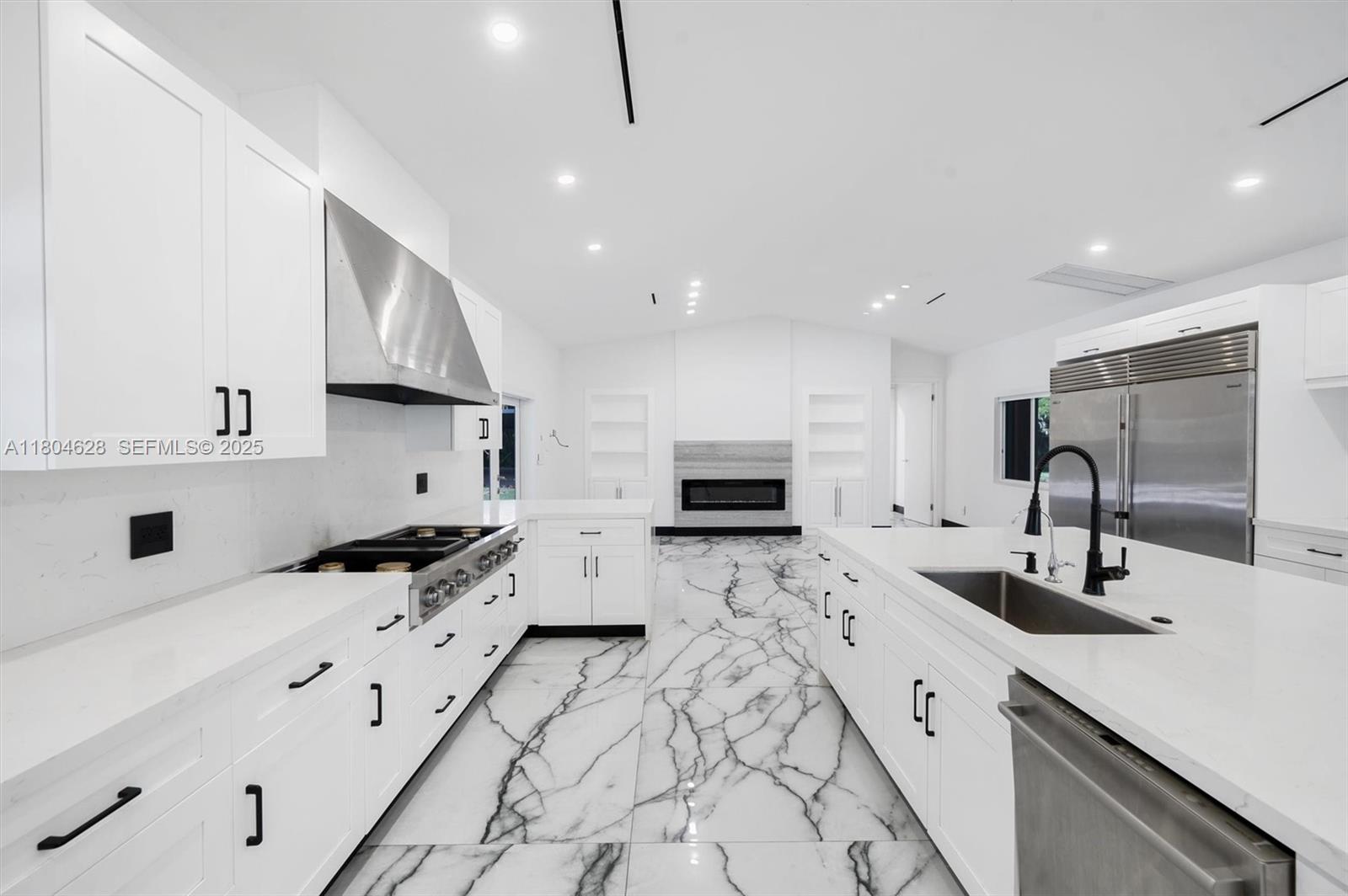 5121 Southwest 210th Terrace Southwest Ranches, FL 33332 - Photo 17 of 70 a kitchen with stainless steel appliances a sink a stove a microwave a sink and cabinets