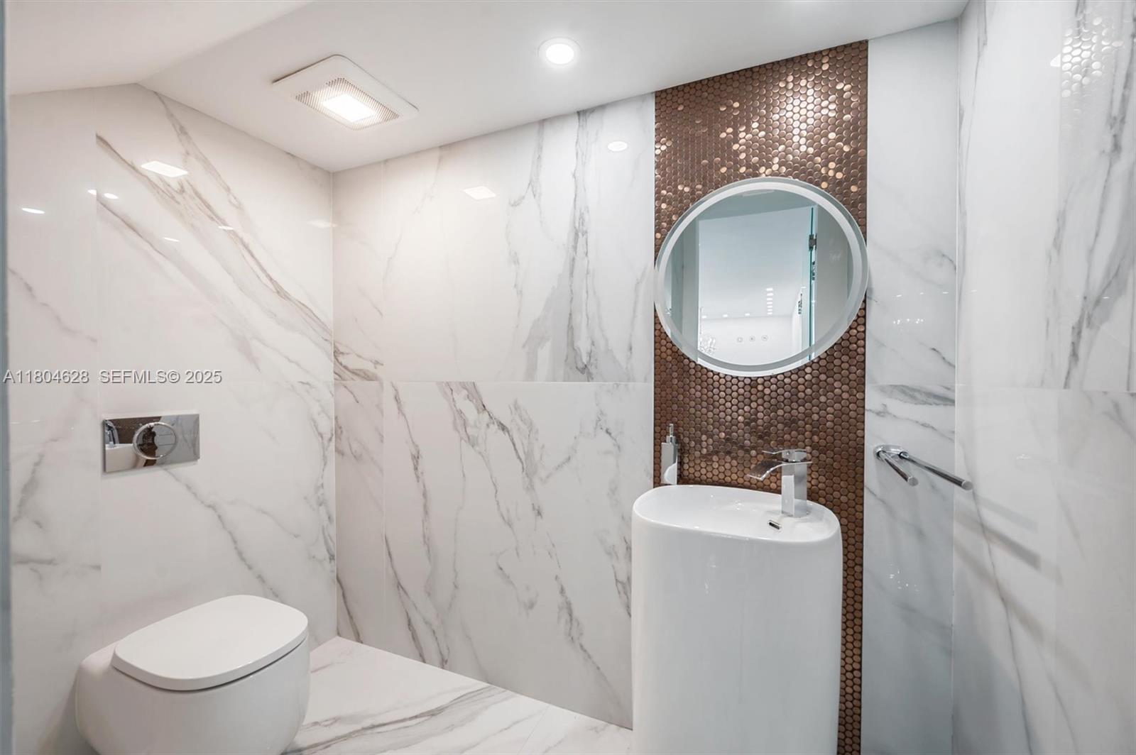 5121 Southwest 210th Terrace Southwest Ranches, FL 33332 - Photo 19 of 70 a bathroom with a toilet a sink and a mirror