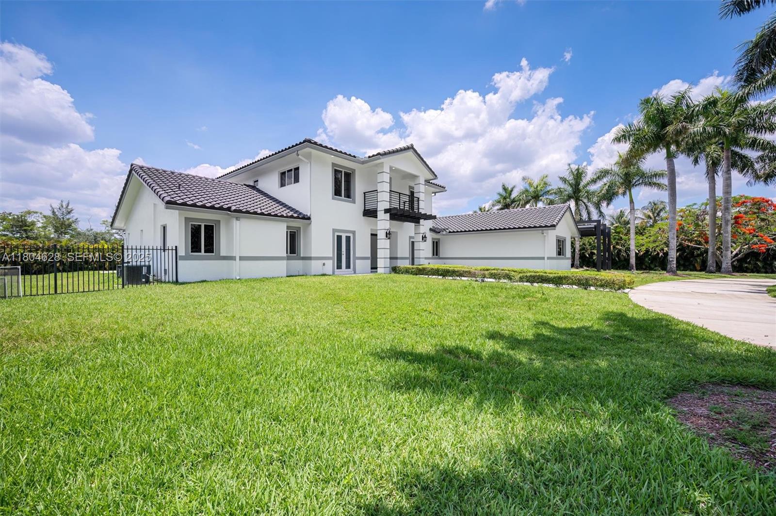 5121 Southwest 210th Terrace Southwest Ranches, FL 33332 - Photo 2 of 70 a front view of house with yard and green space