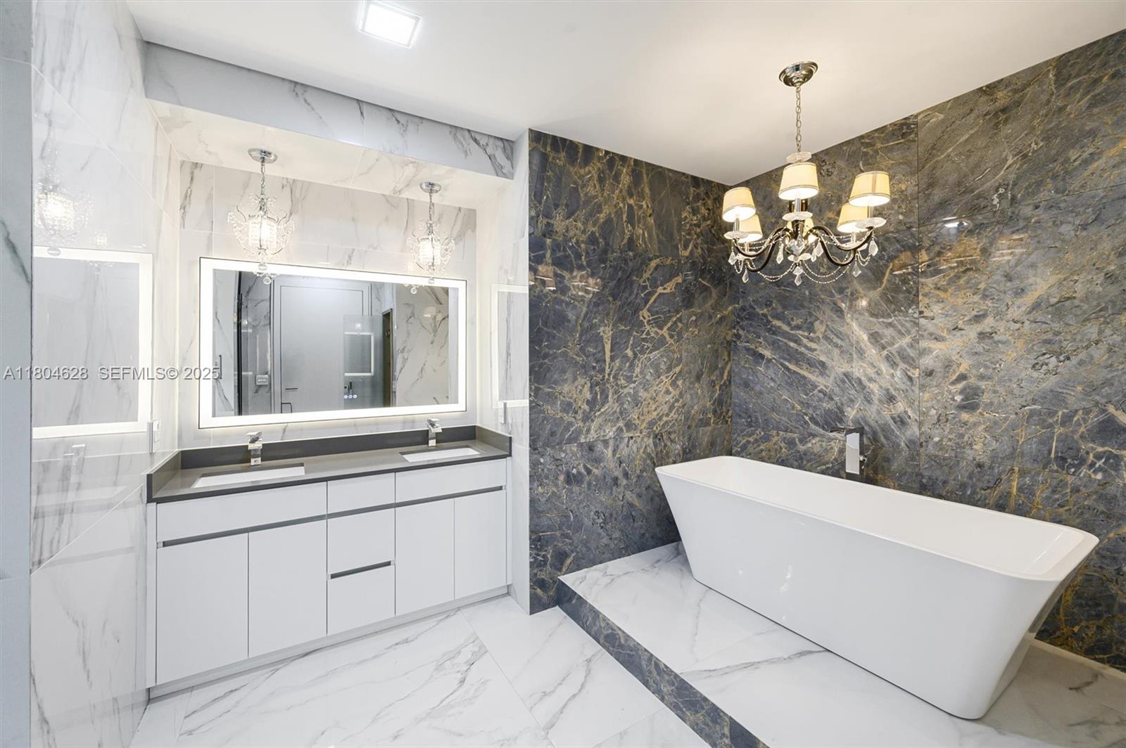 5121 Southwest 210th Terrace Southwest Ranches, FL 33332 - Photo 22 of 70 a bathroom with a double vanity sink mirror and shower