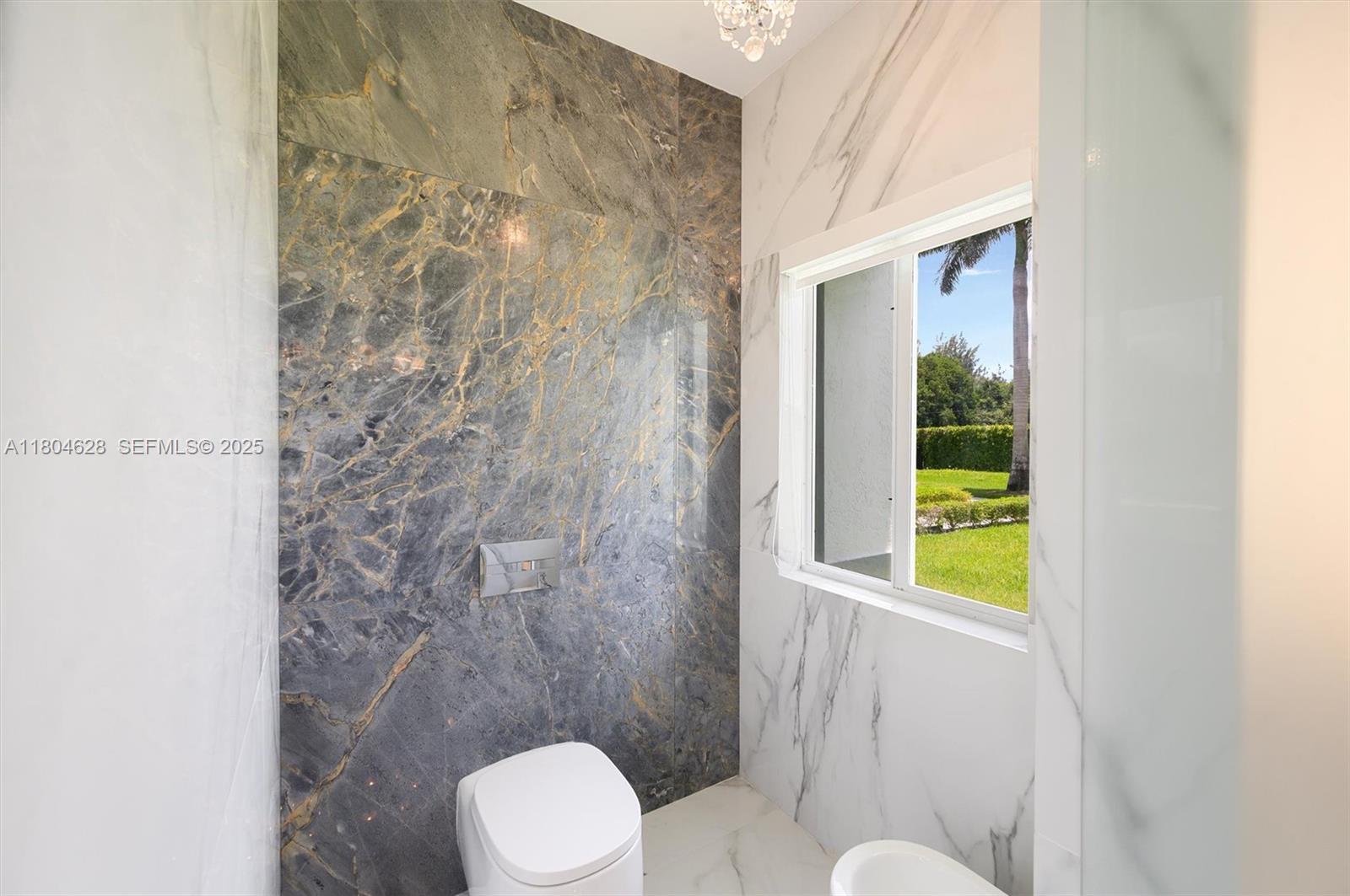 5121 Southwest 210th Terrace Southwest Ranches, FL 33332 - Photo 23 of 70 a white toilet sitting next to a shower curtain